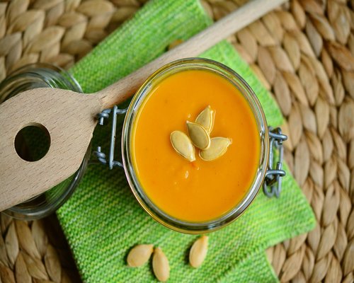 A warm bowl of homemade soup with fresh vegetables